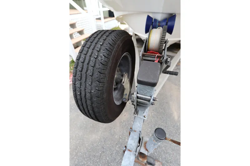 Slide: The Image of Trailer wheel and winch of a 2013 Boston Whaler 210 Montauk boat. - 36