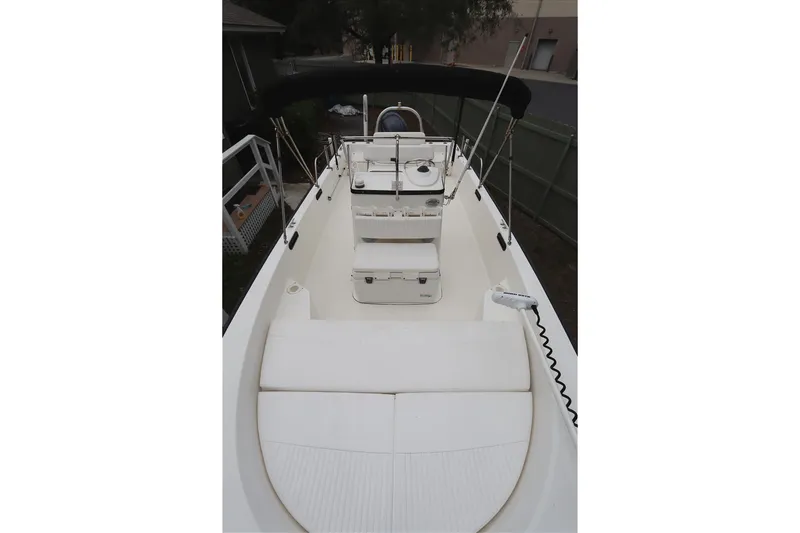 Slide: The Image of 2013 Boston Whaler 210 Montauk boat interior with seating and console. - 5