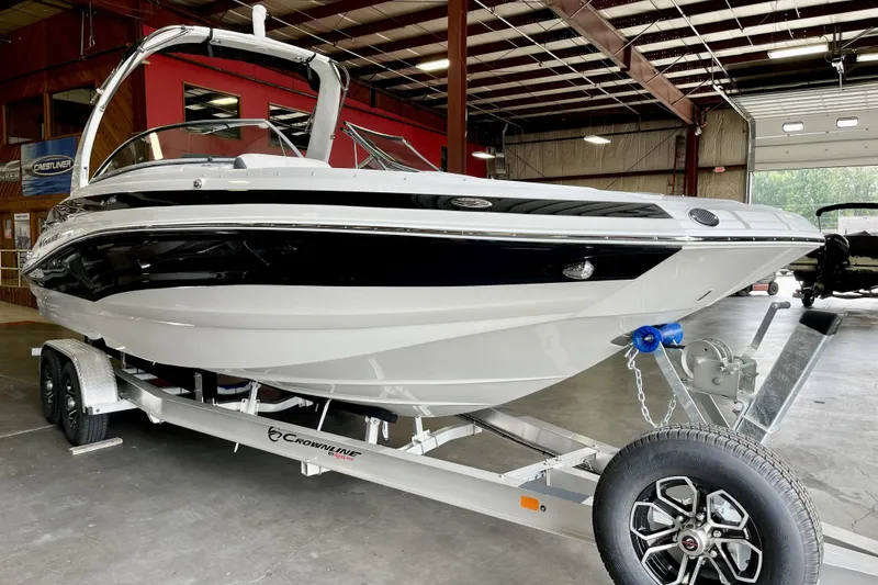 The Image of 2024 Crownline Eclipse E290 XS boat on trailer in indoor showroom. - 0
