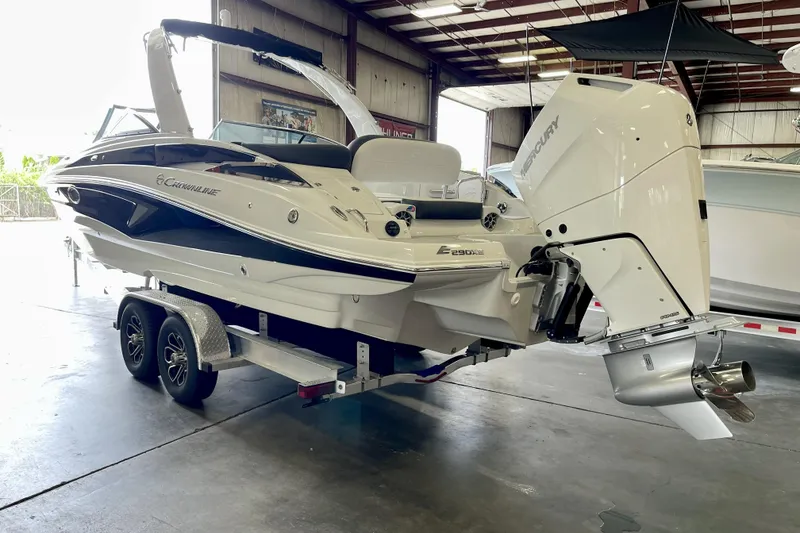 Slide: The Image of 2024 Crownline Eclipse E290 XS boat on trailer in indoor showroom. - 2