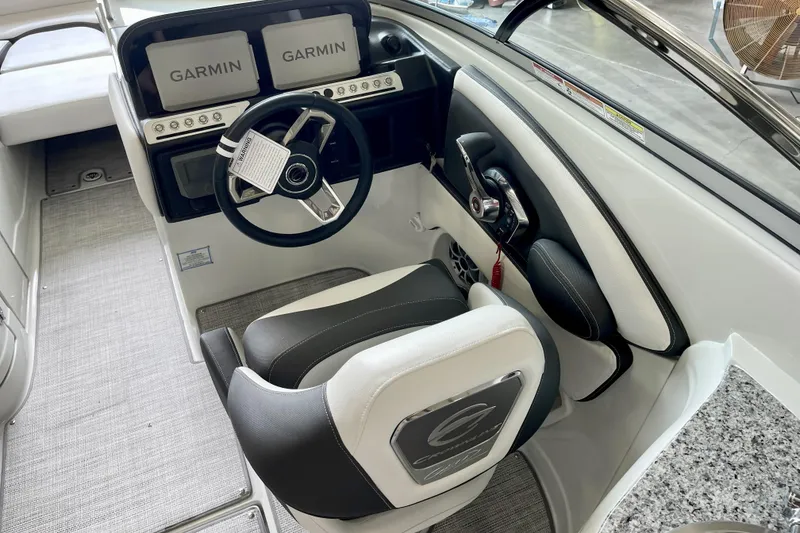 Slide: The Image of 2024 Crownline Eclipse E290 XS boat cockpit with Garmin displays and modern steering wheel. - 8