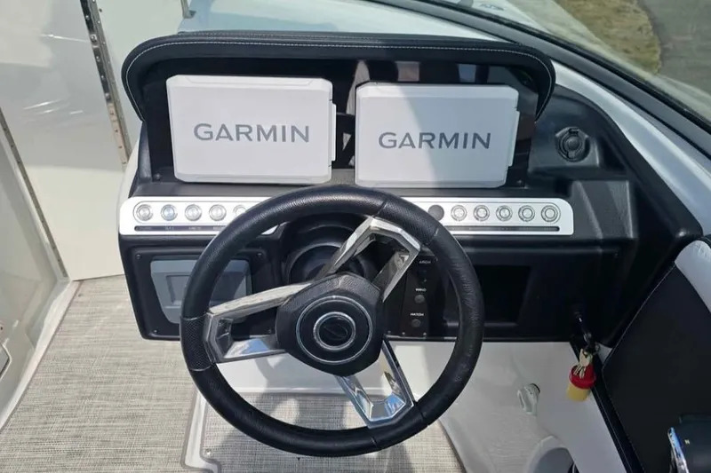 Slide: The Image of 2024 Crownline Eclipse E290 XS dashboard with dual Garmin displays and steering wheel. - 9