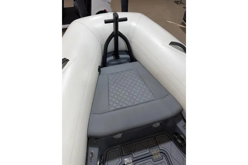 Slide: The Image of 2026 Brig Navigator 24 boat interior with cushioned seating and modern design. - 11