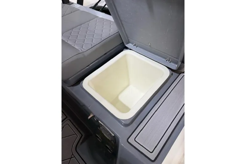Slide: The Image of Open storage compartment on 2026 Brig Navigator 24 boat with cushioned seating. - 15
