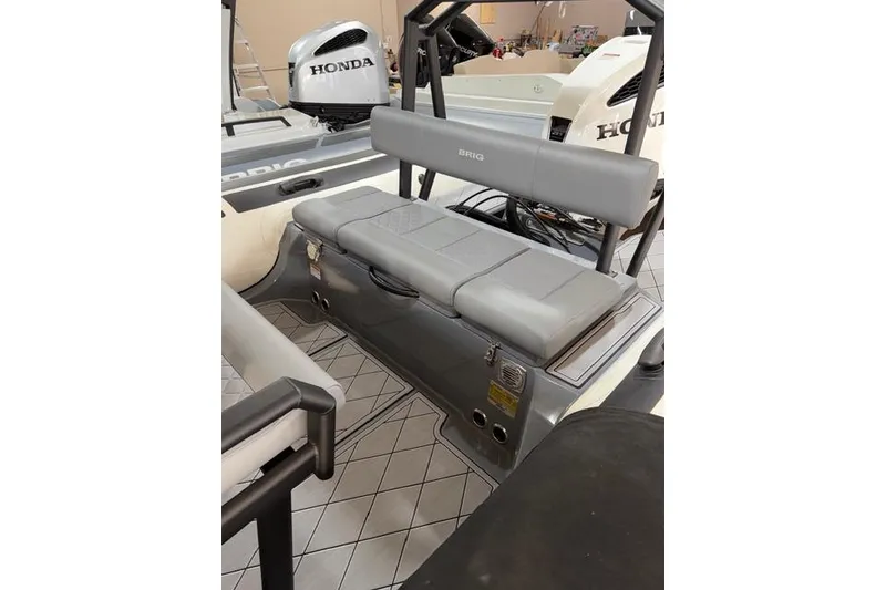Slide: The Image of 2026 Brig Navigator 24 boat with Honda engine, featuring gray seating and modern design. - 8
