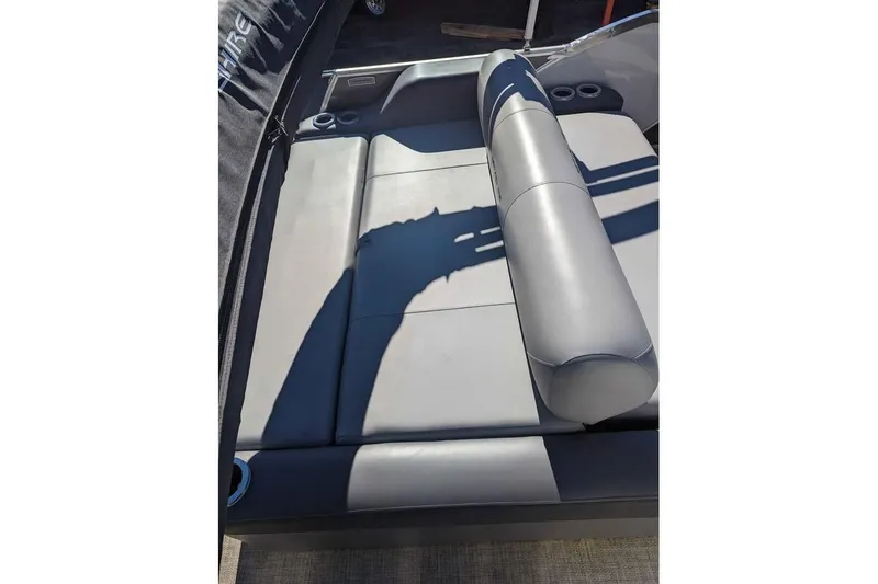 Slide: The Image of 2021 Berkshire 23ULX boat interior with gray cushioned seating and cup holders. - 10
