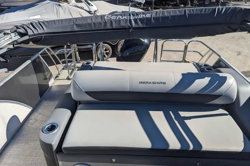Slide: The Image of 2021 Berkshire 23ULX pontoon boat with cushioned seating and covered canopy. - 11