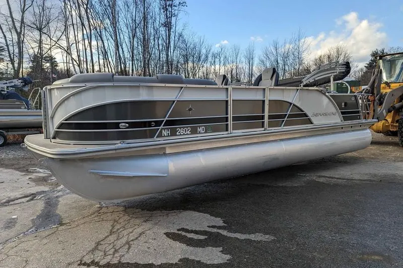 Slide: The Image of 2021 Berkshire 23ULX pontoon boat on a trailer, parked outdoors. - 3