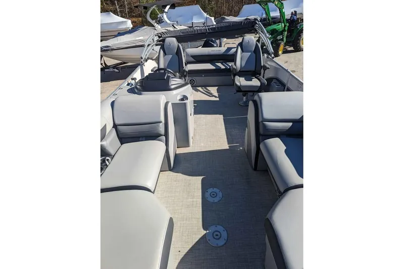 Slide: The Image of 2021 Berkshire 23ULX pontoon boat interior with gray seating and steering console. - 4