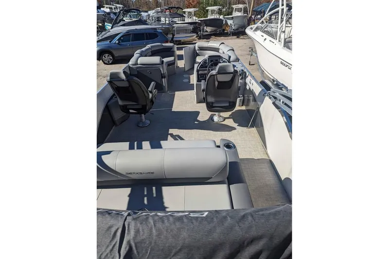 Slide: The Image of 2021 Berkshire 23ULX pontoon boat interior with seating and steering console. - 5