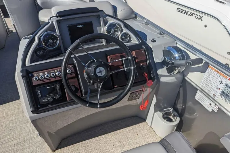 Slide: The Image of 2021 Berkshire 23ULX boat dashboard with steering wheel and control panel. - 6