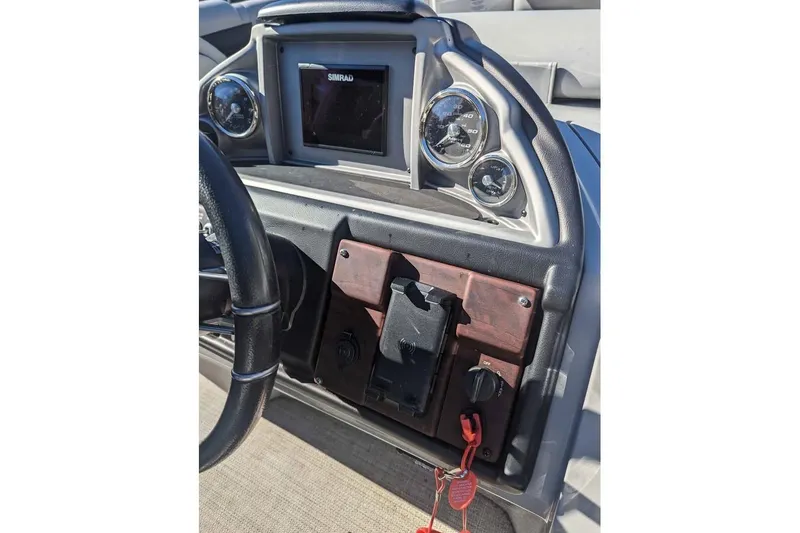 Slide: The Image of Dashboard of 2021 Berkshire 23ULX boat with steering wheel and gauges. - 7