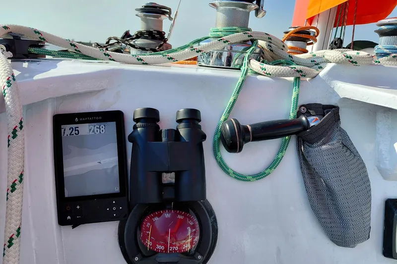 Slide: The Image of Cockpit of 1979 Newick Native sailboat with navigation tools and ropes. - 10