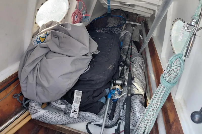 Slide: The Image of Interior of a 1979 Newick Native boat with fishing gear and ropes. - 11