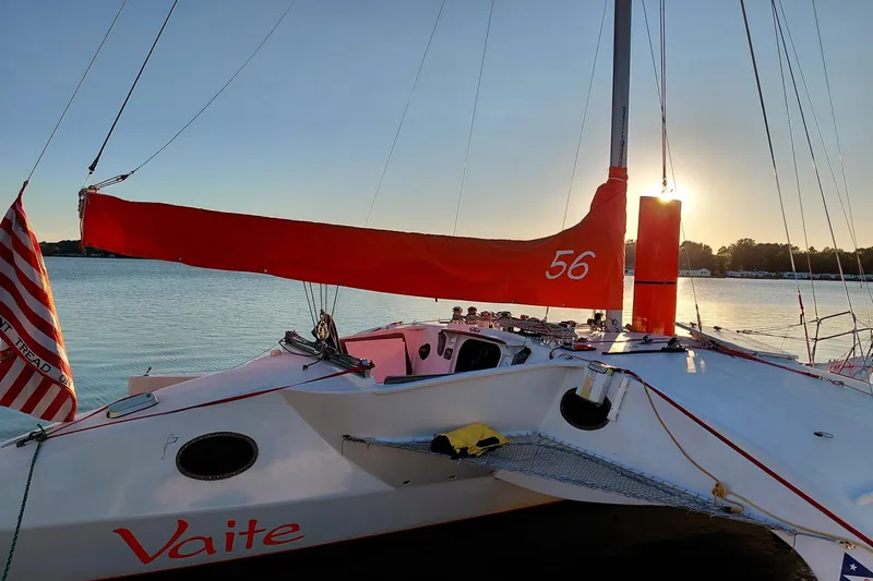 Slide: The Image of Sailboat "Vaite" with red sail, Newick Native 1979, on calm water at sunset. - 8
