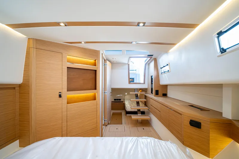 Slide: The Image of 2024 Pardo Yachts P43 cruising on a sunny day near lush greenery. - 54