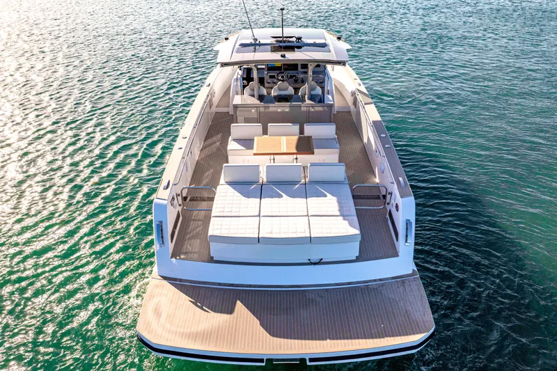 Slide: The Image of 2024 Pardo Yachts P43 luxury yacht on calm water with cityscape background. - 56