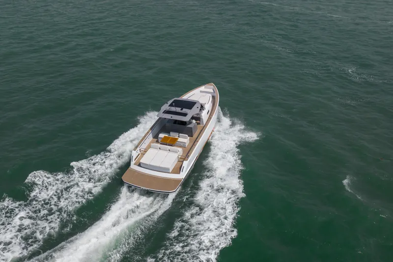 Slide: The Image of 2024 Pardo Yachts P43 luxury yacht with sleek design and spacious seating on blue water. - 6