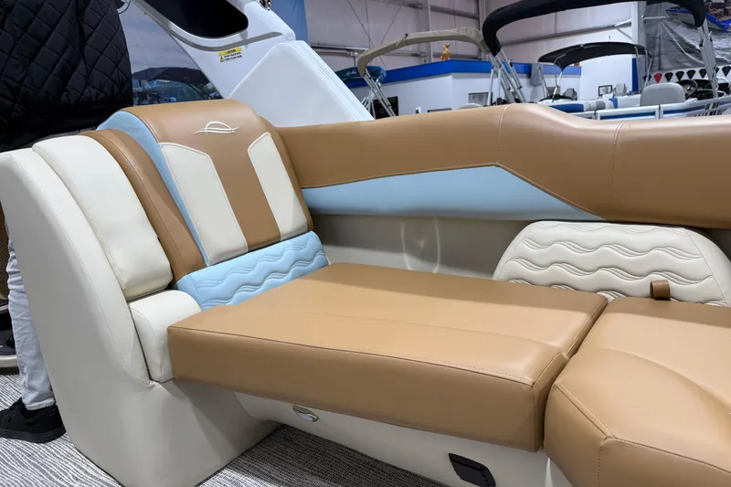 Slide: The Image of Luxurious seating on 2026 SunCatcher Diamond Elite 324 RC boat, featuring tan and blue upholstery. - 10