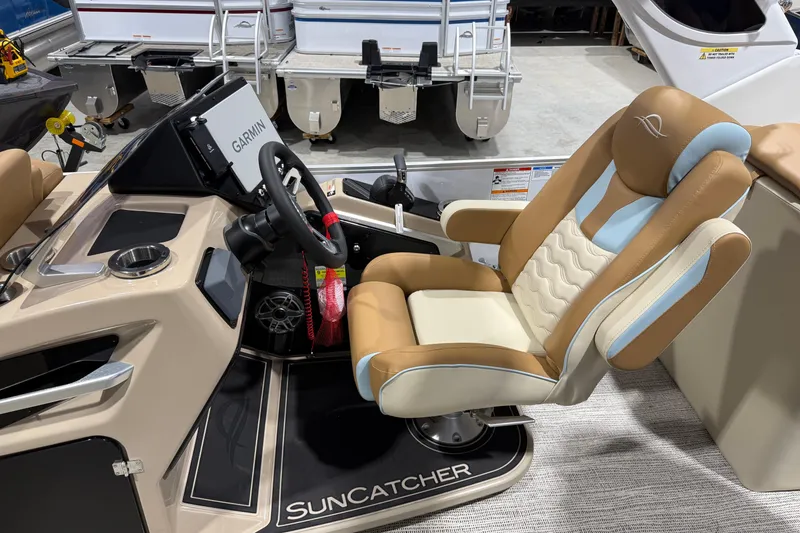 Slide: The Image of 2026 SunCatcher Diamond Elite 324 RC boat interior with Garmin navigation and luxurious captain's chair. - 6