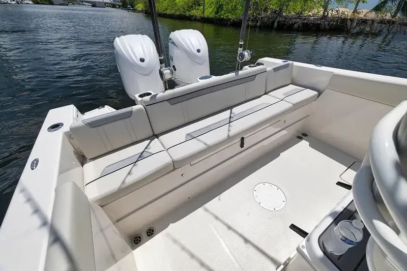 Slide: The Image of Manufacturer Provided Image: 2026 Sailfish 252 CC boat interior with seating and dual engines on a sunny day. - 15