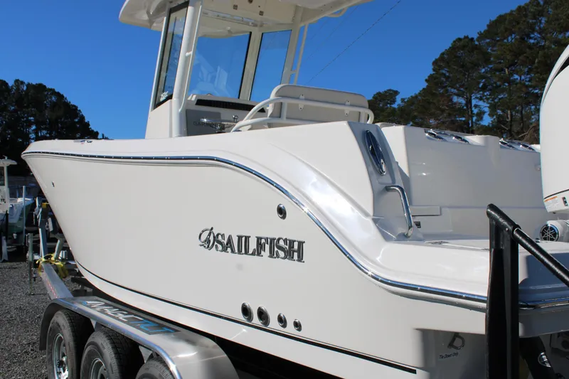 Slide: The Image of 2026 Sailfish 252 CC boat on trailer, side view, outdoors. - 18