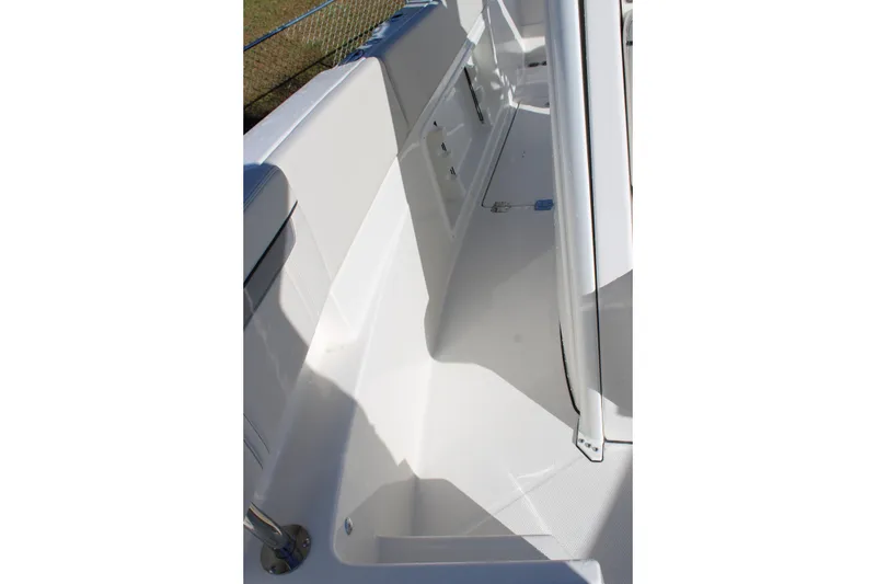 Slide: The Image of 2026 Sailfish 252 CC boat interior, featuring sleek white deck and storage compartments. - 28