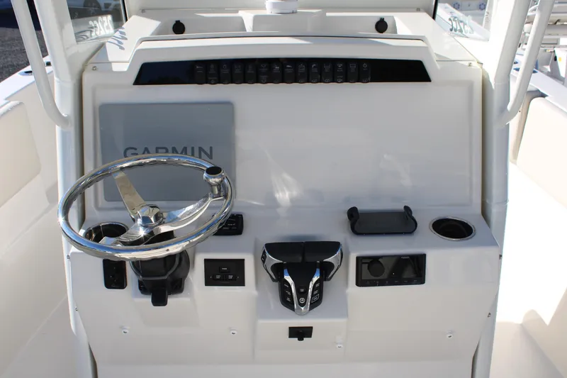 Slide: The Image of 2026 Sailfish 252 CC boat console with Garmin navigation and steering wheel. - 38