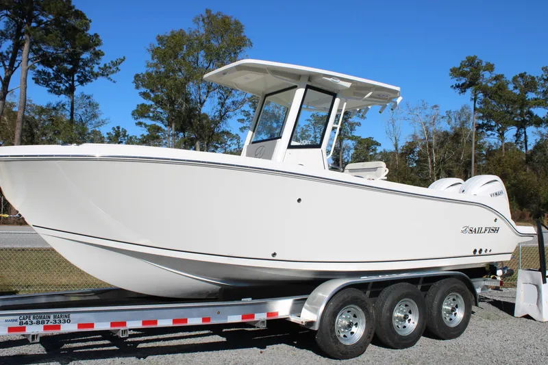 Slide: The Image of 2026 Sailfish 252 CC boat on trailer, parked outdoors, clear sky background. - 4