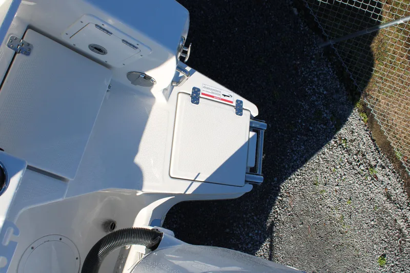 Slide: The Image of 2026 Sailfish 252 CC boat deck with storage compartments and ladder. - 42