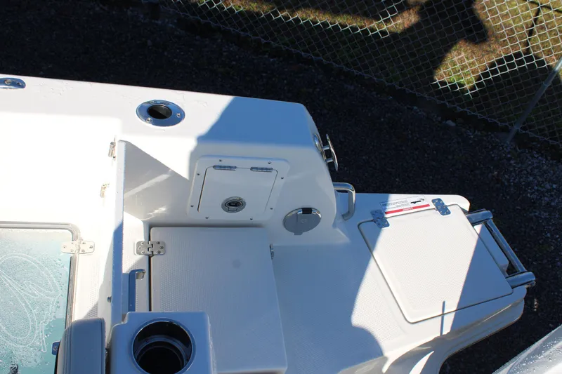 Slide: The Image of 2026 Sailfish 252 CC boat deck with storage compartments and cup holder. - 43