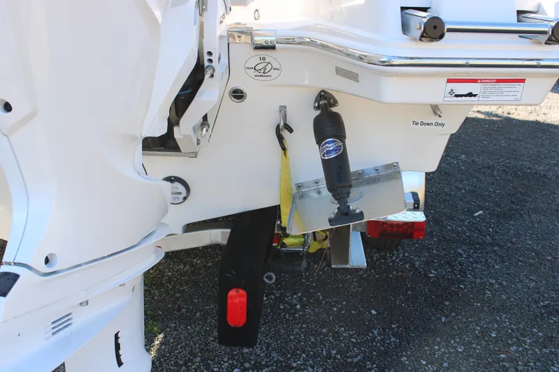 Slide: The Image of 2026 Sailfish 252 CC boat stern with motor and tie-down details. - 45