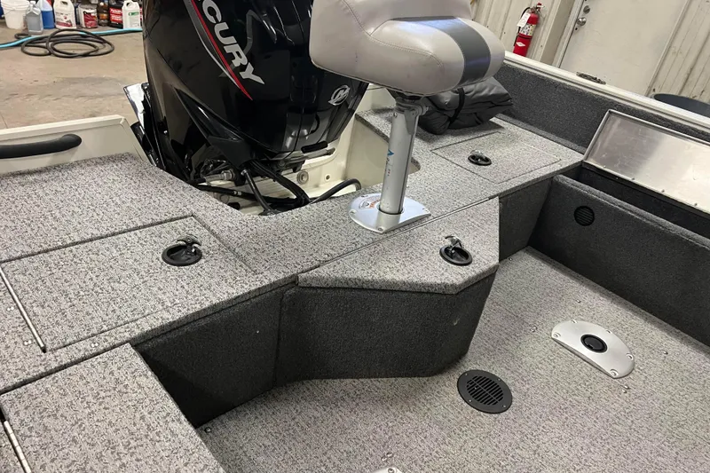 Slide: The Image of 2022 Tracker Pro Guide V-16 WT boat interior with Mercury engine and seating. - 10