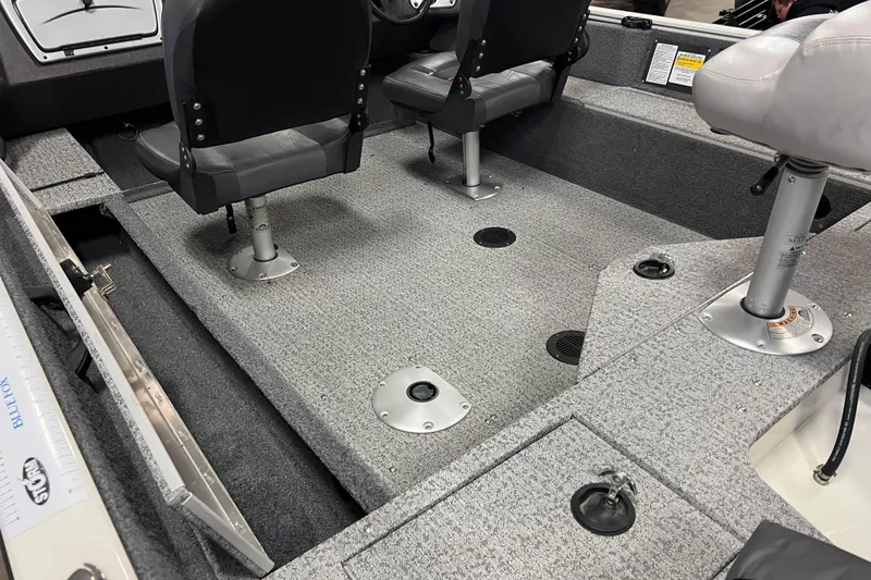 Slide: The Image of 2022 Tracker Pro Guide V-16 WT boat interior with seating and carpeted flooring. - 12