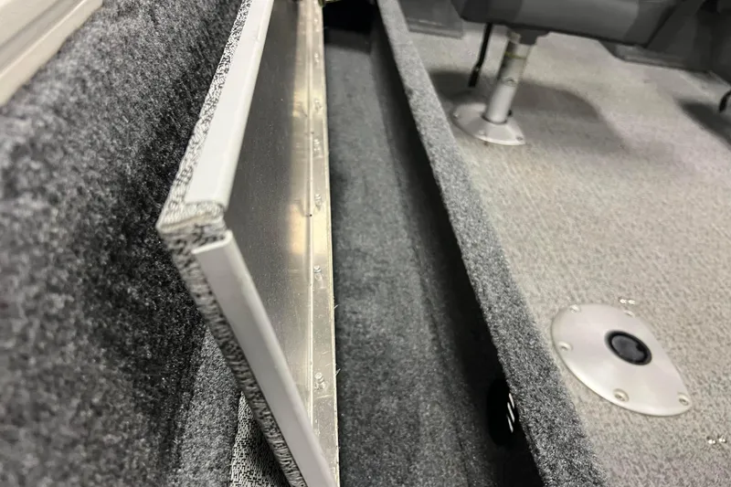 Slide: The Image of 2022 Tracker Pro Guide V-16 WT interior, featuring carpeted storage and seating area. - 13