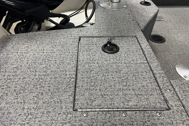 Slide: The Image of 2022 Tracker Pro Guide V-16 WT boat deck with storage compartment and textured surface. - 16