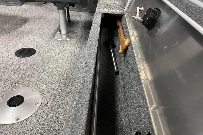 Slide: The Image of 2022 Tracker Pro Guide V-16 WT boat interior with storage compartment and tools. - 18