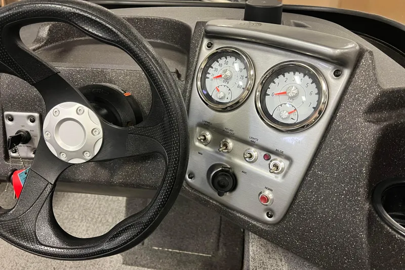 Slide: The Image of 2022 Tracker Pro Guide V-16 WT dashboard with steering wheel and instrument panel. - 19