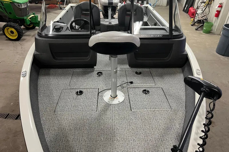 Slide: The Image of 2022 Tracker Pro Guide V-16 WT boat interior with seating and equipment. - 2