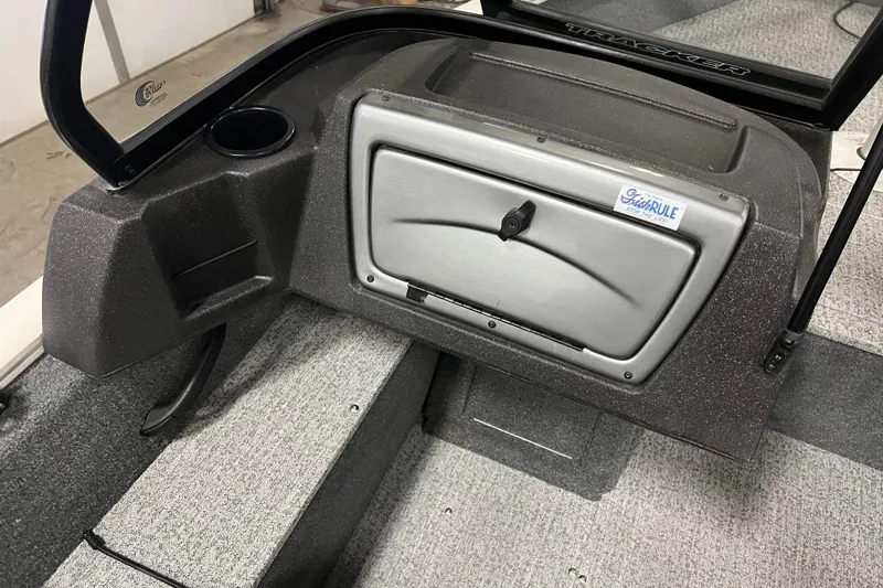 Slide: The Image of 2022 Tracker Pro Guide V-16 WT boat interior with storage compartment and cup holder. - 23