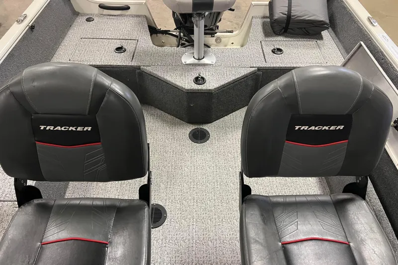 Slide: The Image of 2022 Tracker Pro Guide V-16 WT boat interior with two black seats and gray carpet. - 24