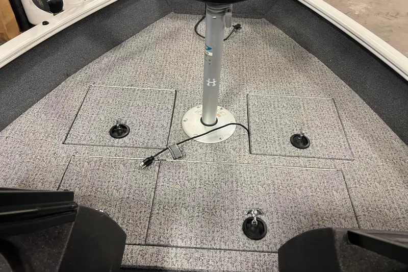 Slide: The Image of 2022 Tracker Pro Guide V-16 WT boat interior with storage compartments and pedestal base. - 27