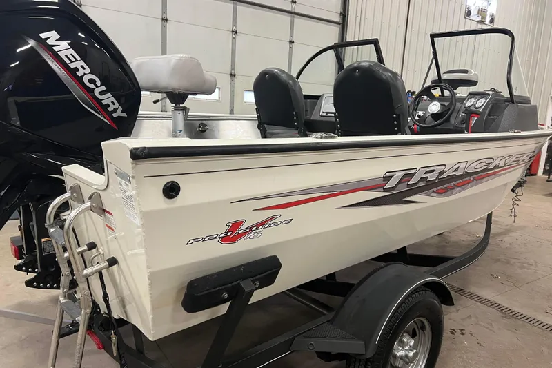 Slide: The Image of 2022 Tracker Pro Guide V-16 WT boat with Mercury engine in a garage. - 3