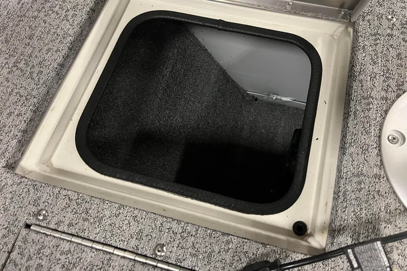 Slide: The Image of Open storage compartment in 2022 Tracker Pro Guide V-16 WT boat. - 30