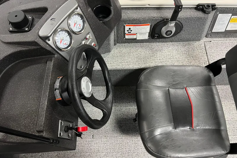 Slide: The Image of 2022 Tracker Pro Guide V-16 WT boat interior with steering wheel and seat. - 36