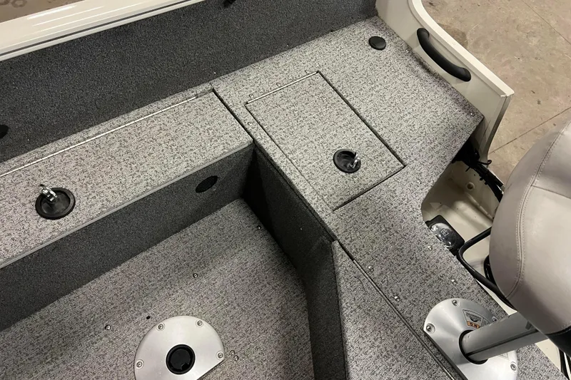 Slide: The Image of 2022 Tracker Pro Guide V-16 WT boat interior with gray carpet and seating. - 38