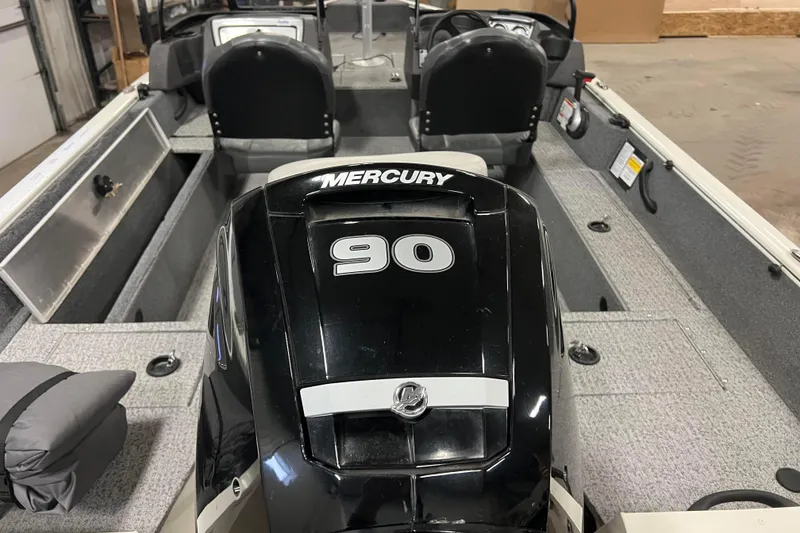 Slide: The Image of 2022 Tracker Pro Guide V-16 WT boat with Mercury 90 engine in a garage. - 4