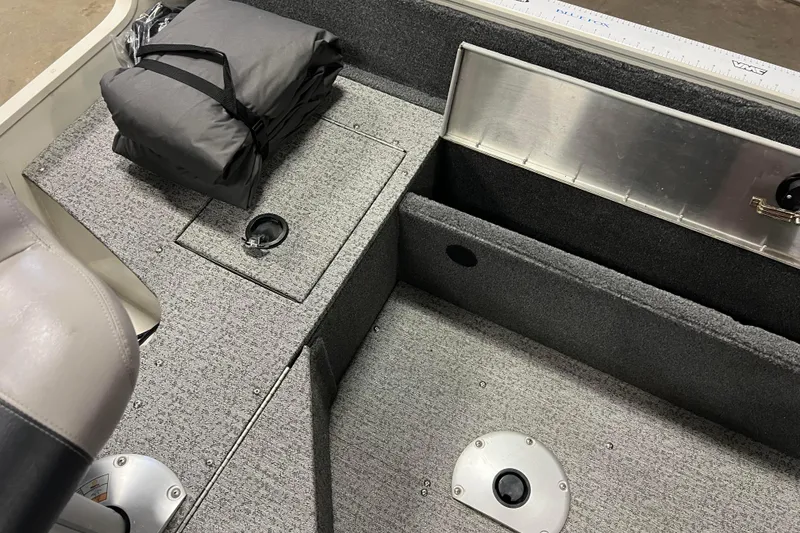 Slide: The Image of 2022 Tracker Pro Guide V-16 WT boat interior with storage compartments and seating. - 40