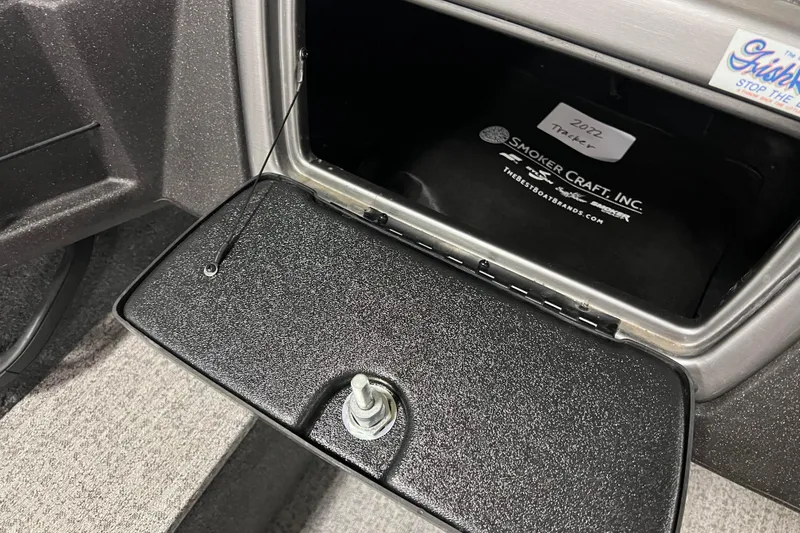 Slide: The Image of 2022 Tracker Pro Guide V-16 WT boat compartment with Smoker Craft Inc. branding. - 42