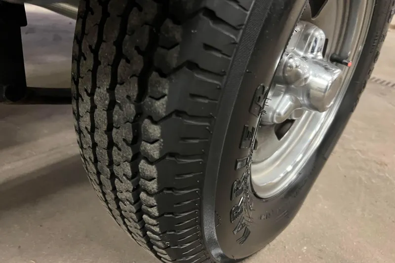 Slide: The Image of Close-up of a 2022 Tracker Pro Guide V-16 WT trailer tire and wheel. - 43